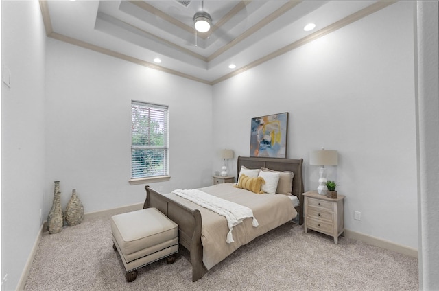 bedroom with light carpet, a tray ceiling, crown molding, and baseboards