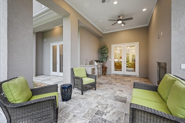 view of patio with ceiling fan, area for grilling, and french doors