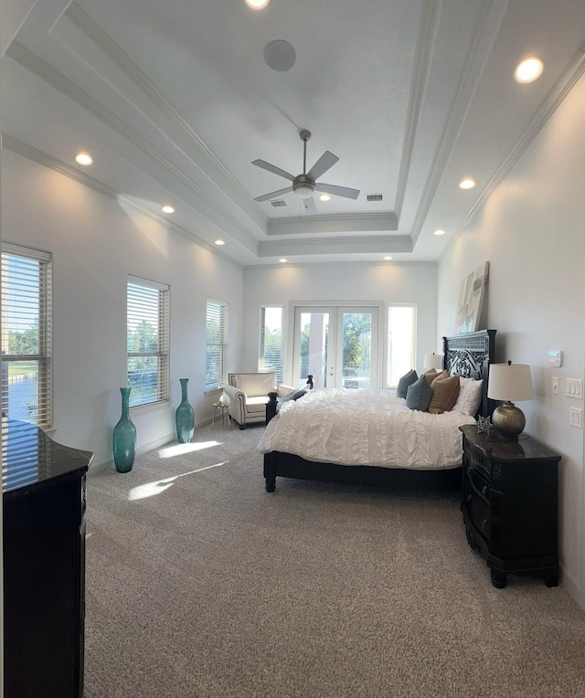 carpeted bedroom featuring recessed lighting, visible vents, french doors, a raised ceiling, and crown molding