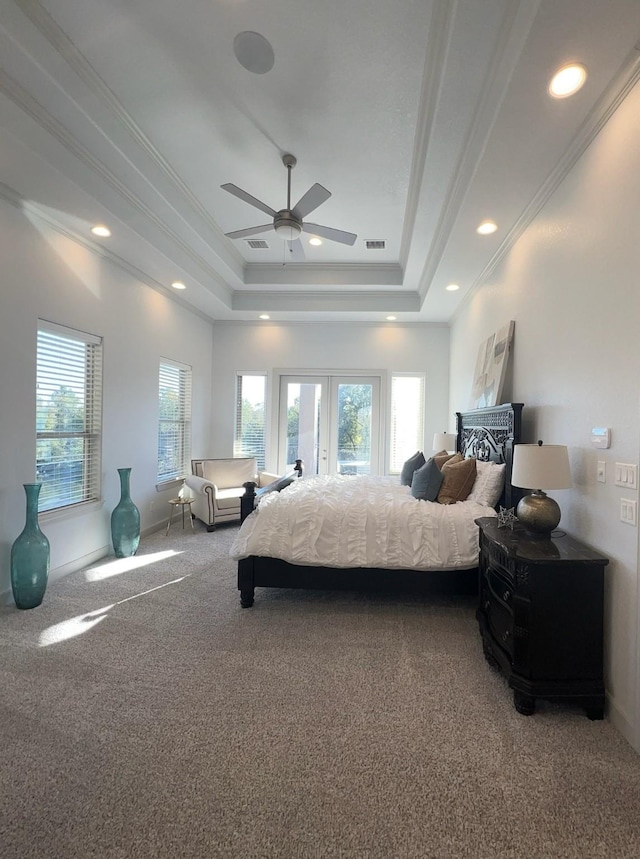 bedroom with carpet, a raised ceiling, ceiling fan, and ornamental molding