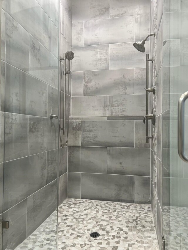 bathroom featuring a shower with shower door