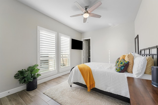 bedroom featuring light hardwood / wood-style floors and ceiling fan