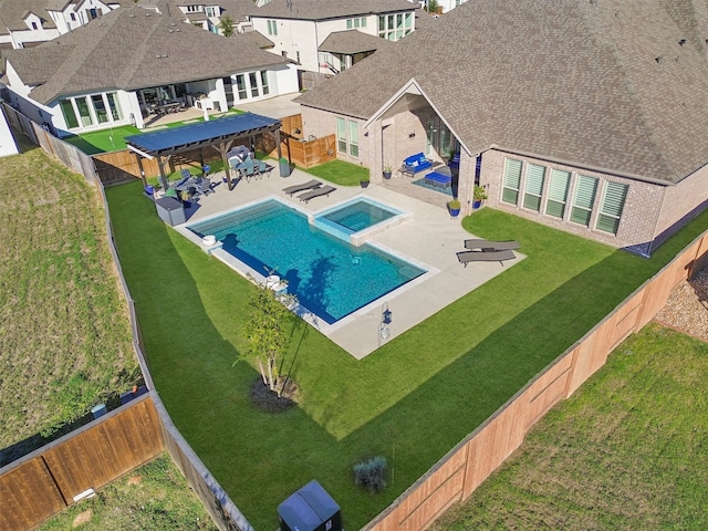 view of pool featuring an in ground hot tub, a yard, and a patio area