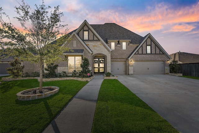 english style home with french doors and a lawn