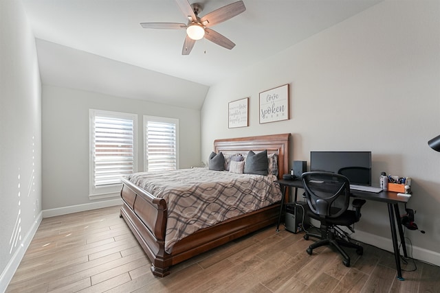 bedroom with ceiling fan, light hardwood / wood-style flooring, and vaulted ceiling