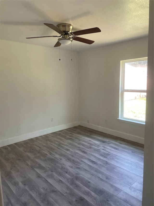 empty room featuring hardwood / wood-style floors and ceiling fan