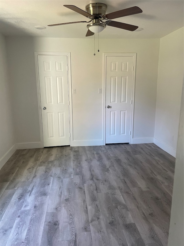 unfurnished bedroom featuring ceiling fan and hardwood / wood-style floors