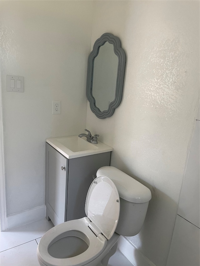 bathroom with tile patterned floors, vanity, and toilet