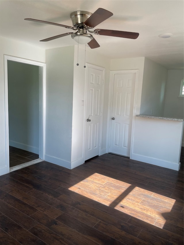 unfurnished bedroom featuring ceiling fan and dark hardwood / wood-style floors