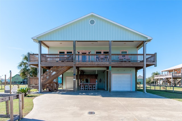 view of front of property with a porch, a garage, and a front yard