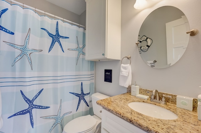 bathroom featuring vanity, toilet, and walk in shower