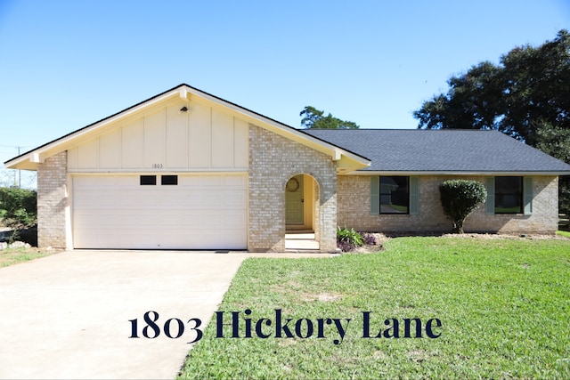 ranch-style home with a garage and a front lawn