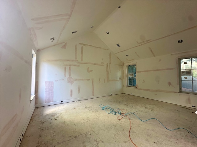 unfurnished room featuring vaulted ceiling