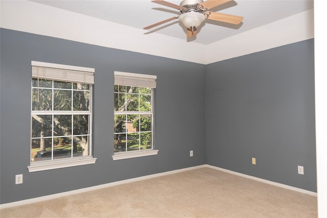 spare room featuring ceiling fan and carpet floors