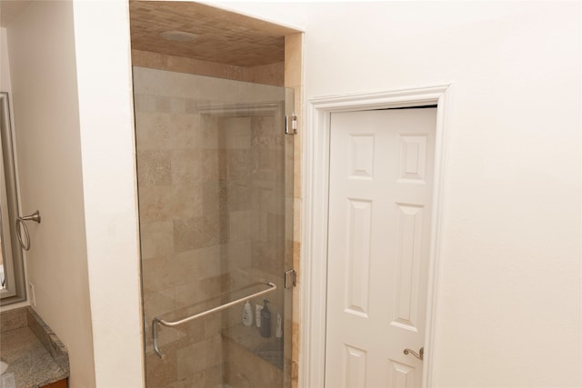 bathroom with a shower with shower door