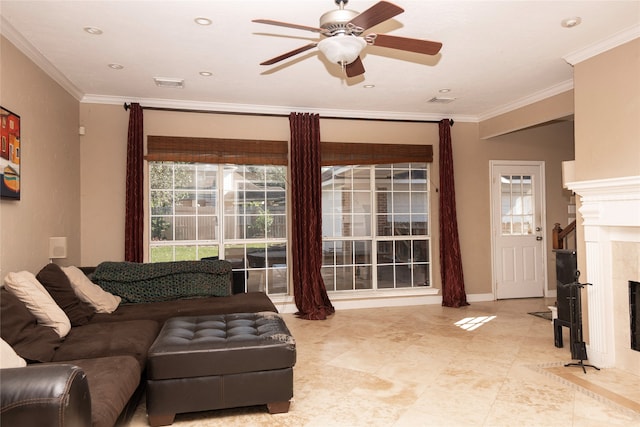 living room featuring a tile fireplace, ceiling fan, and ornamental molding