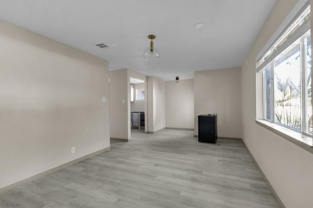 unfurnished living room featuring light wood-type flooring