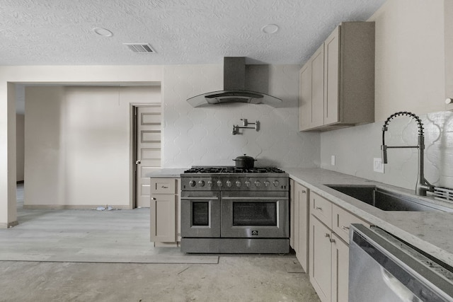 kitchen featuring light stone countertops, sink, stainless steel appliances, extractor fan, and a textured ceiling