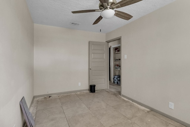 spare room featuring ceiling fan and a textured ceiling