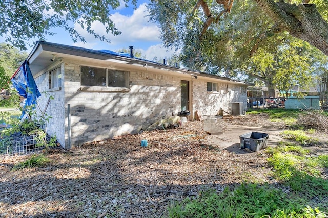 rear view of property with central AC