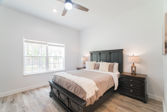 bedroom with light hardwood / wood-style flooring and ceiling fan