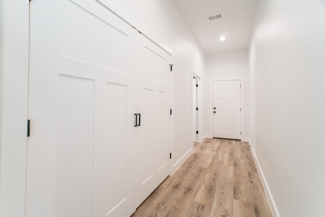 hall with light hardwood / wood-style floors