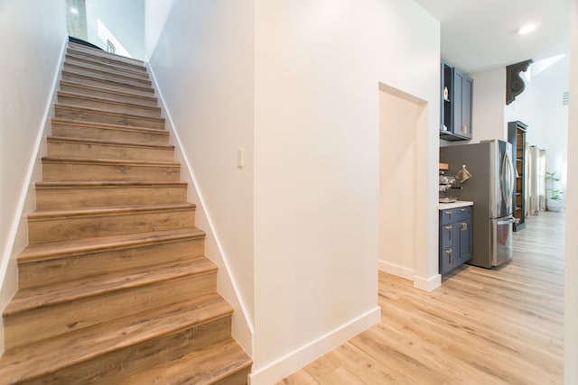 stairs featuring hardwood / wood-style flooring