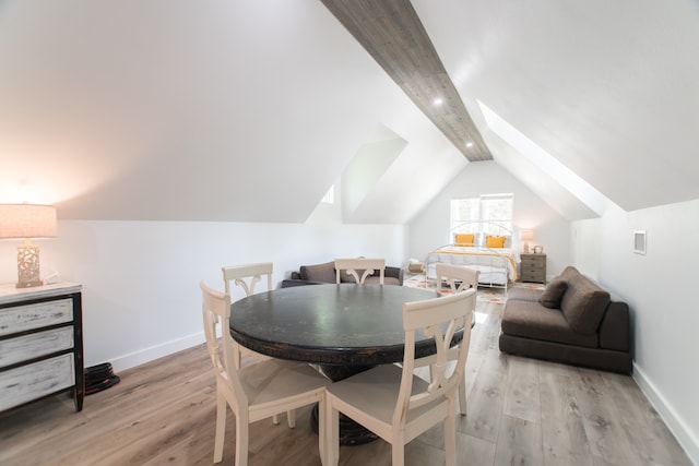 dining room with light hardwood / wood-style floors and lofted ceiling