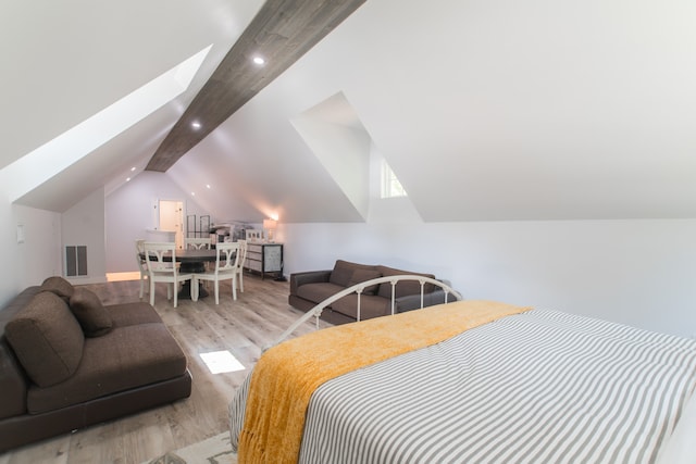 bedroom with lofted ceiling and light hardwood / wood-style flooring