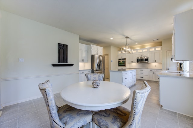 dining room featuring light tile patterned flooring and sink