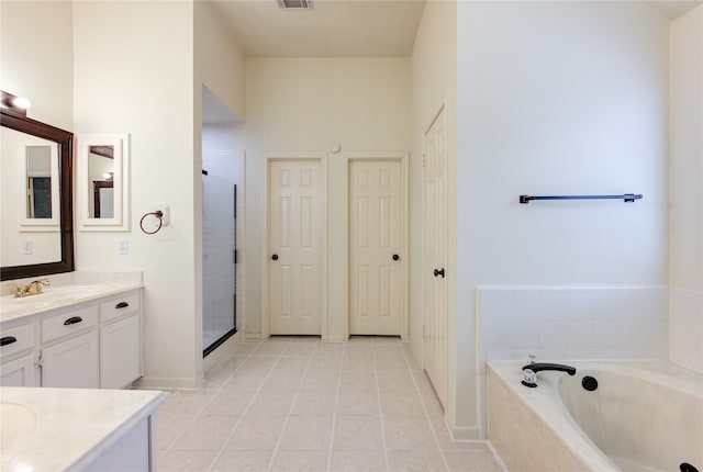 bathroom with tile patterned flooring, vanity, a towering ceiling, and plus walk in shower