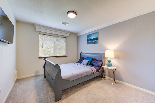 bedroom with light colored carpet and crown molding