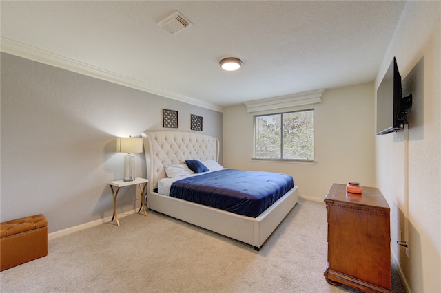 bedroom featuring crown molding and light colored carpet