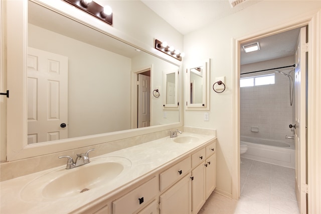 full bathroom with tile patterned flooring, vanity, toilet, and tiled shower / bath combo