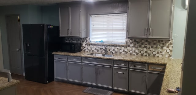 kitchen featuring sink, black appliances, tasteful backsplash, and gray cabinetry