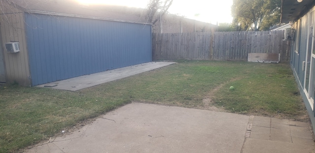 view of yard with a wall mounted air conditioner and a patio