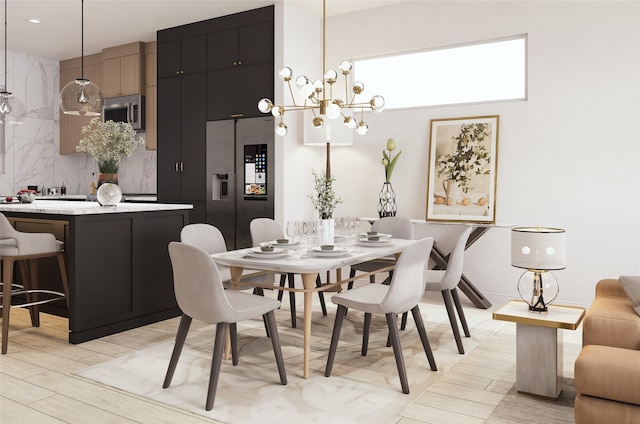 dining area featuring an inviting chandelier and light hardwood / wood-style flooring