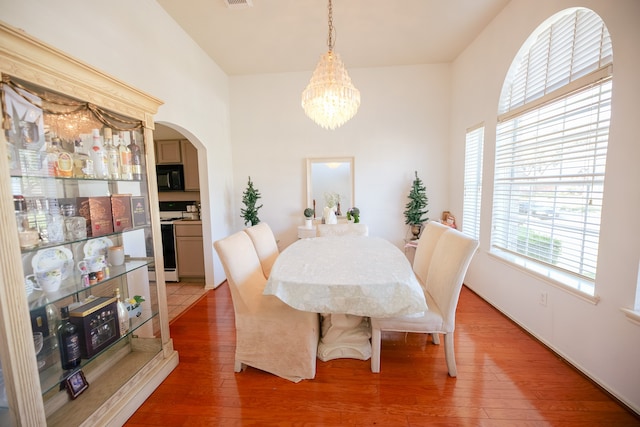 dining room featuring hardwood / wood-style flooring and a notable chandelier