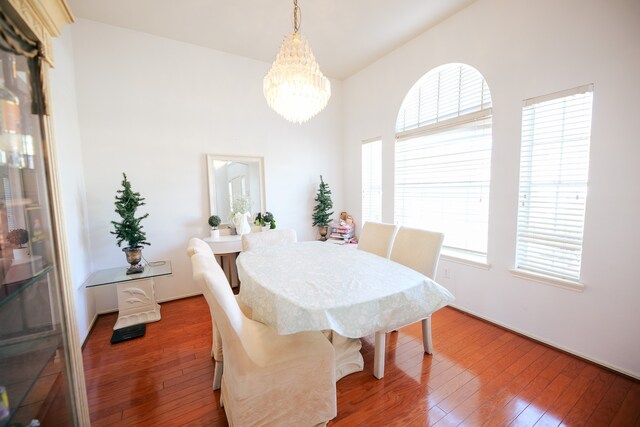 dining area featuring hardwood / wood-style floors, plenty of natural light, and a notable chandelier