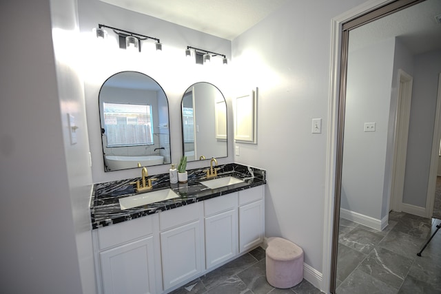 bathroom featuring a tub and vanity