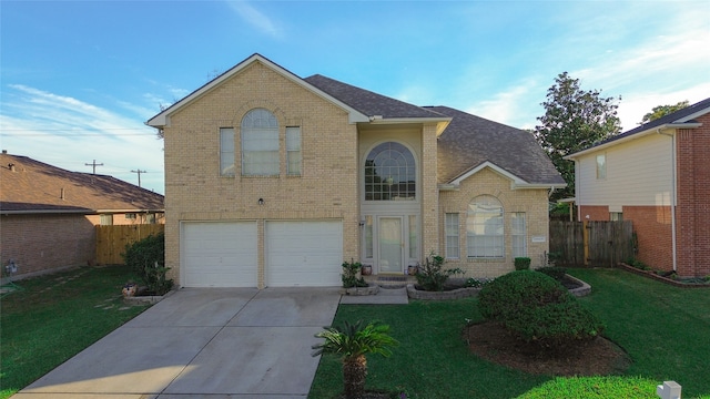 view of front property featuring a garage and a front lawn