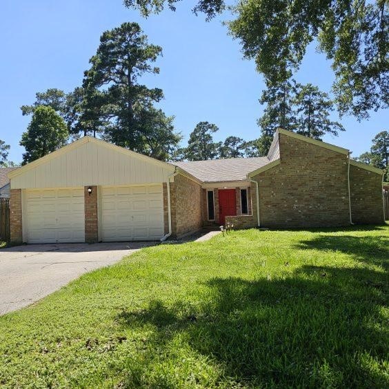 ranch-style home featuring a front yard and a garage