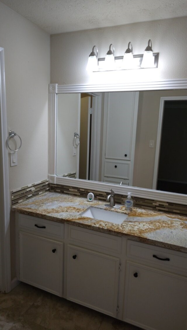 bathroom featuring vanity and a textured ceiling