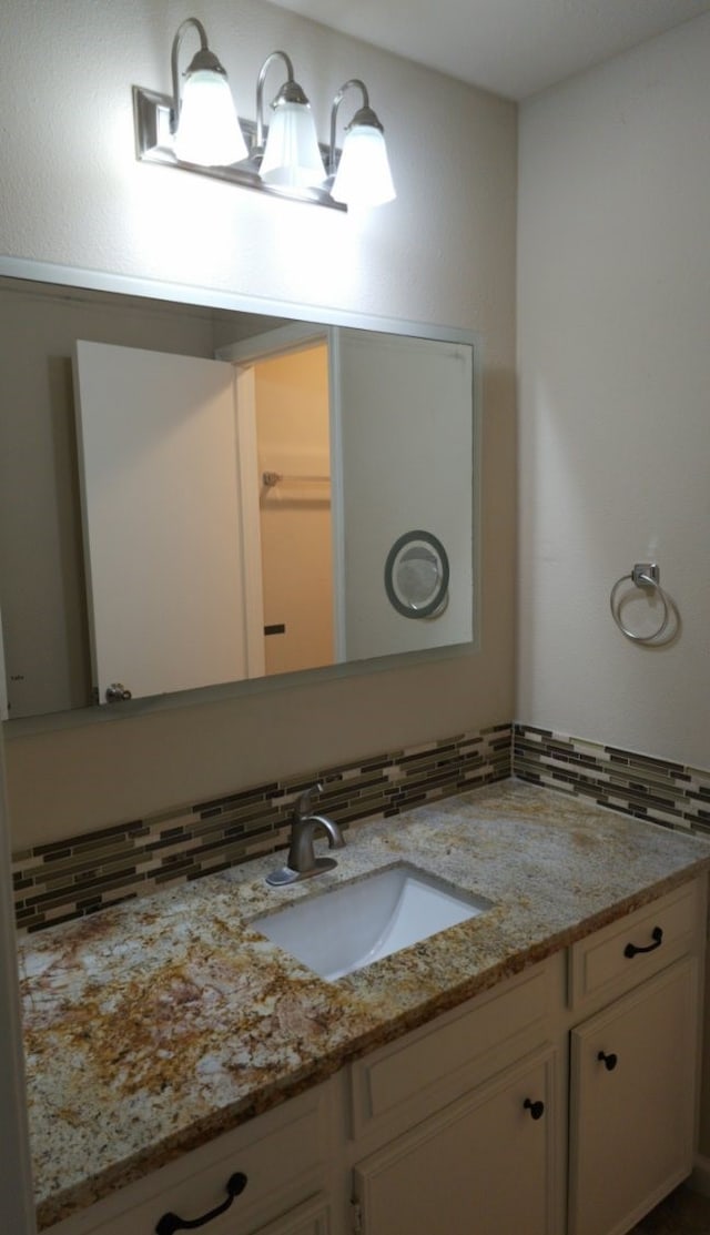 bathroom with decorative backsplash and vanity