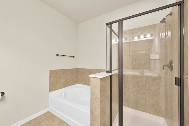 bathroom with tile patterned floors and separate shower and tub