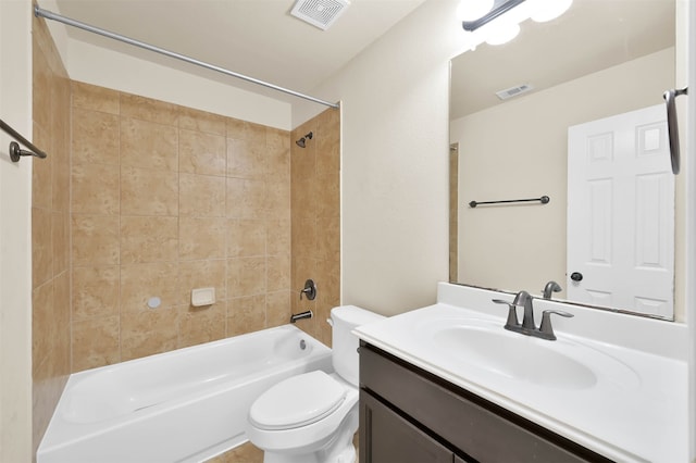 full bathroom with vanity, tiled shower / bath combo, and toilet