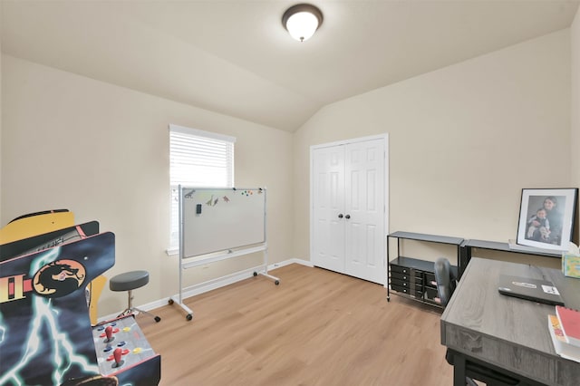 office with vaulted ceiling and hardwood / wood-style flooring