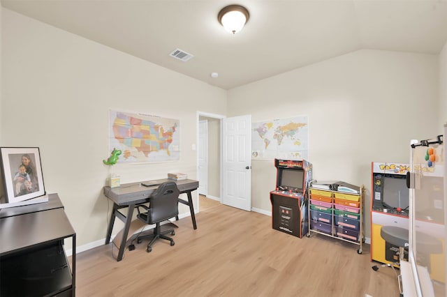 office space with light wood-type flooring and vaulted ceiling