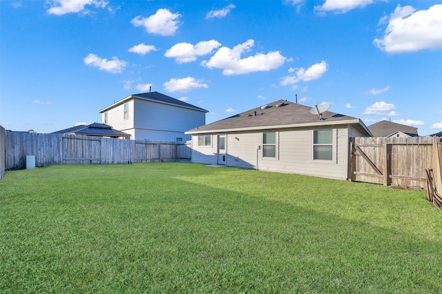 rear view of house with a yard