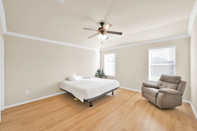 bedroom featuring light hardwood / wood-style floors, ceiling fan, and crown molding